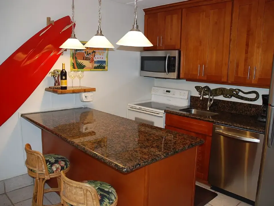 Full kitchen with breakfast bar at Kihei Kai Nani #166