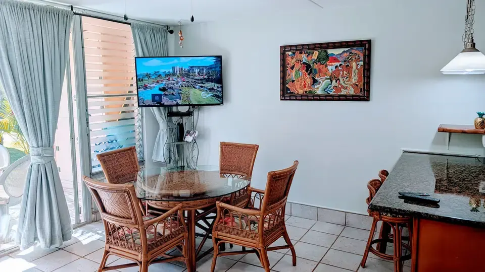 Dining table and television in the condo living area