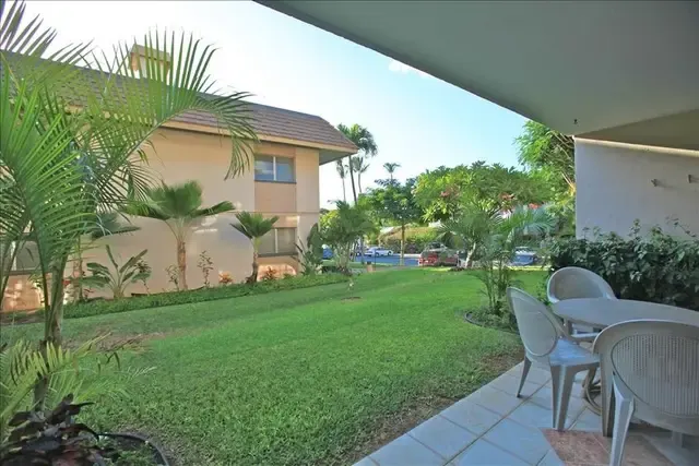 Tropical lawn and garden viewed from the covered lanai