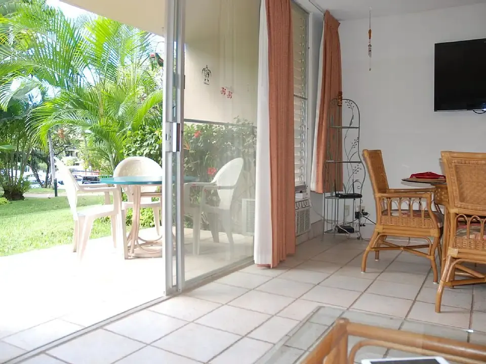 Living and dining area opening to the ground-floor lanai