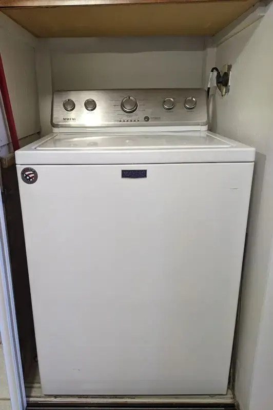 Stacked washer and dryer inside the condo