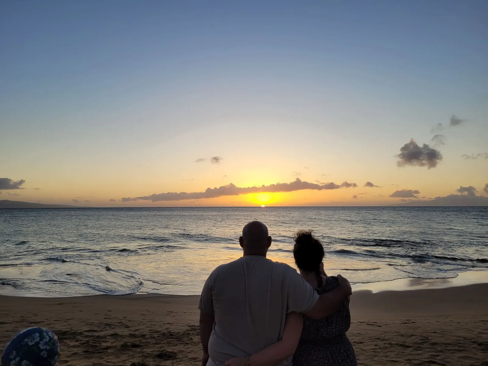 Couple watching the sunset from the beach